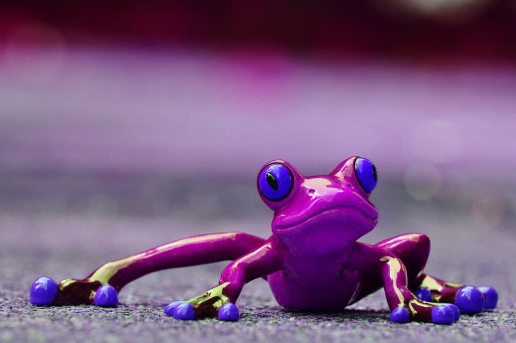 A frog figurine with purple eyes