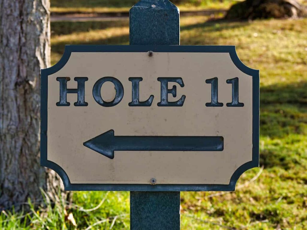 A sign pointing to hole 11