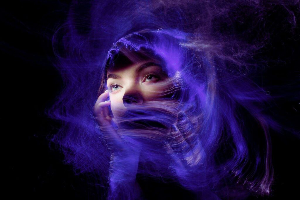A woman surrounded by purple haze