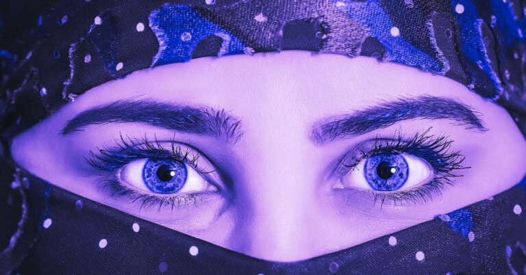 Purple eyes symbolism - A closeup of woman with purple eyes wearing a hijab