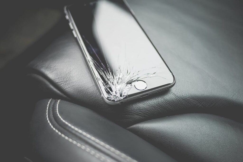 A broken mobile phone on a car seat