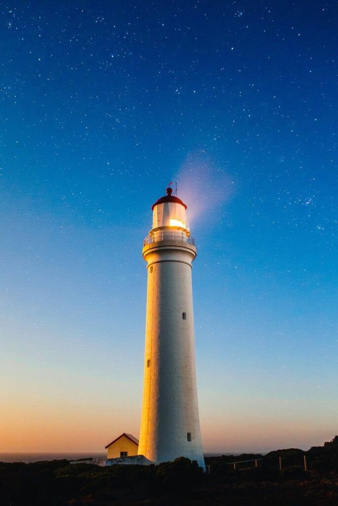 A lighthouse and a starry night sky