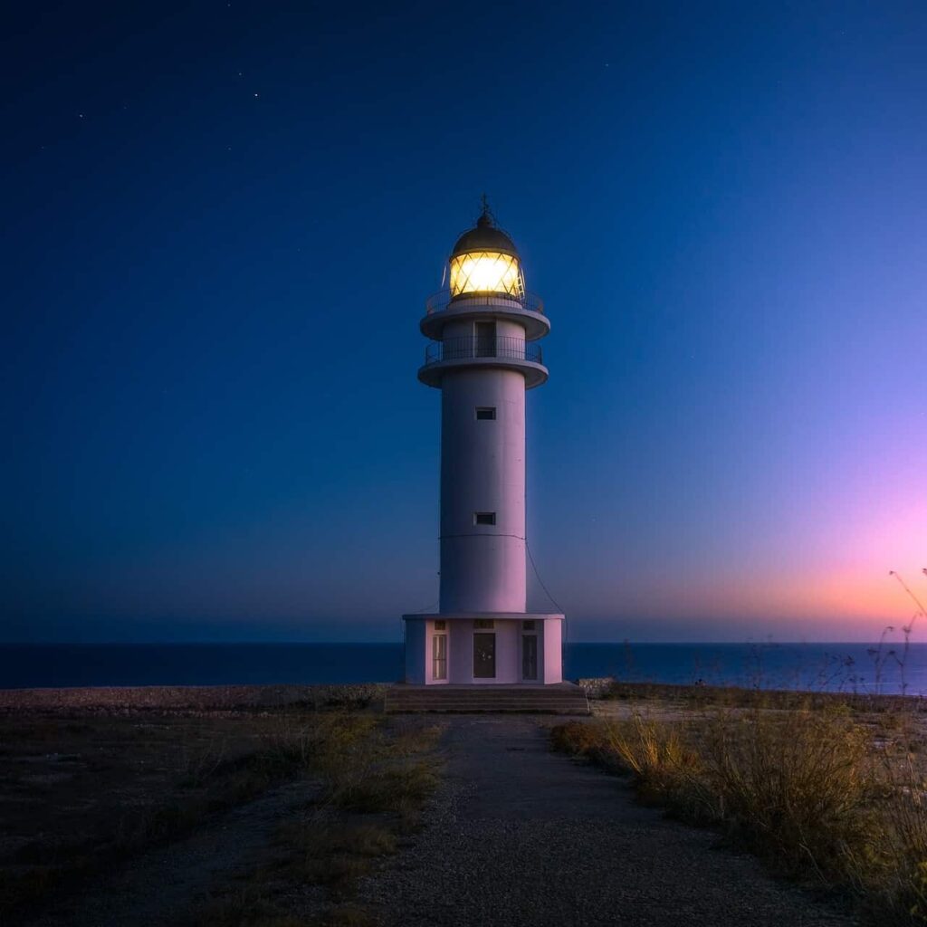 A white lighthouse on the beach