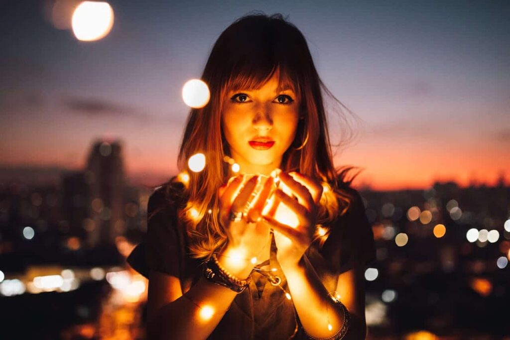 Young woman holding LED lights