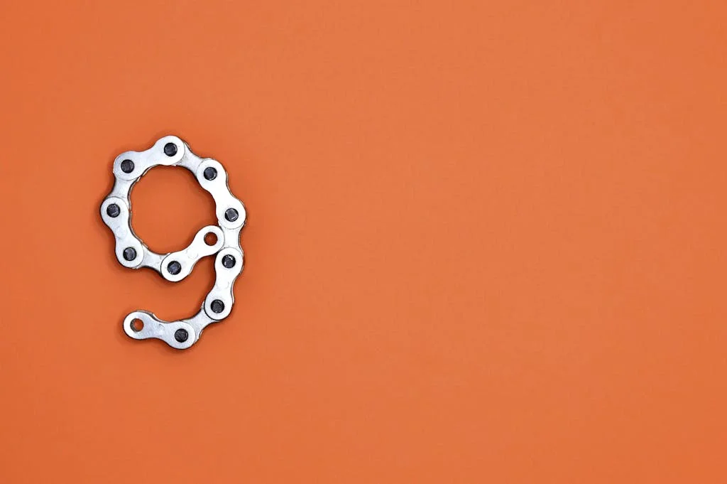 Gray Bicycle Chain on Orange Surface