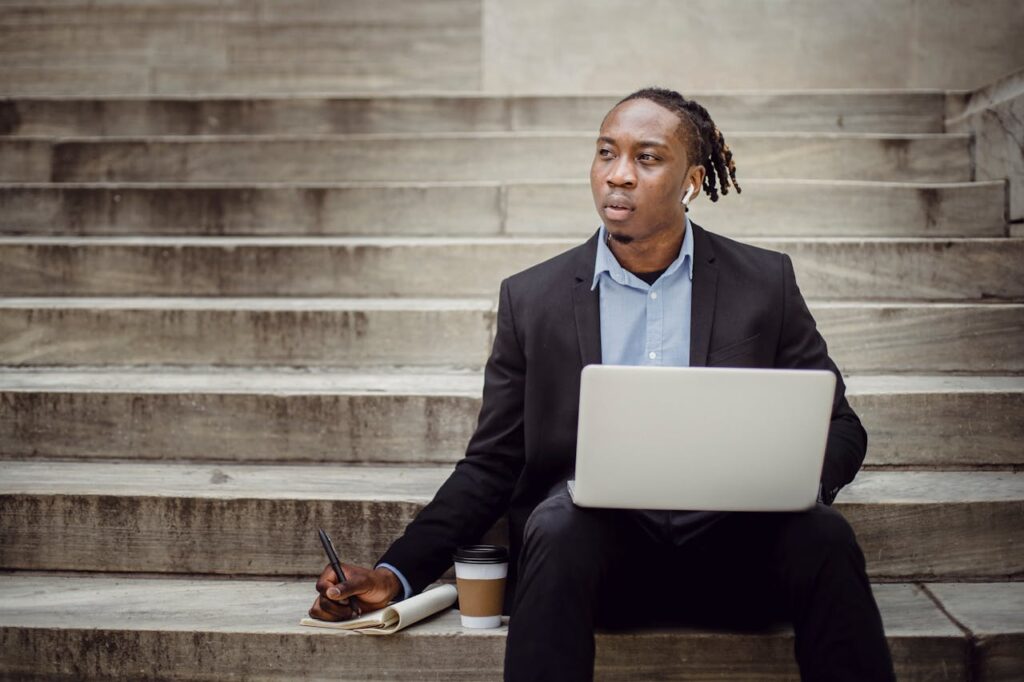 Thoughtful black businessman with a laptop